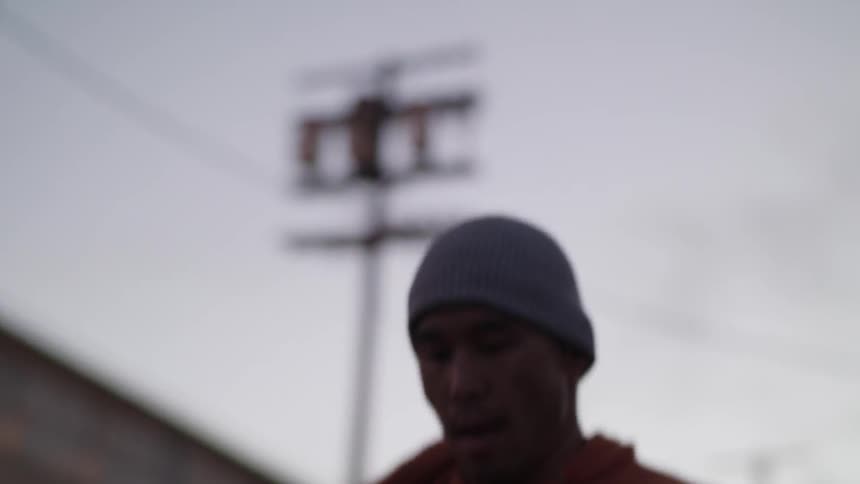 A man is jumping rope on a cloudy day