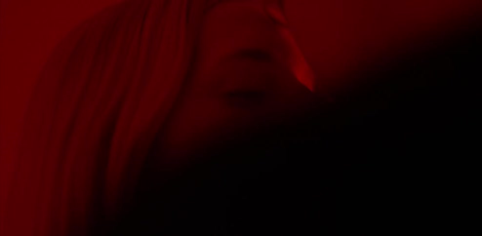 A man and woman are kissing and dancing in a room