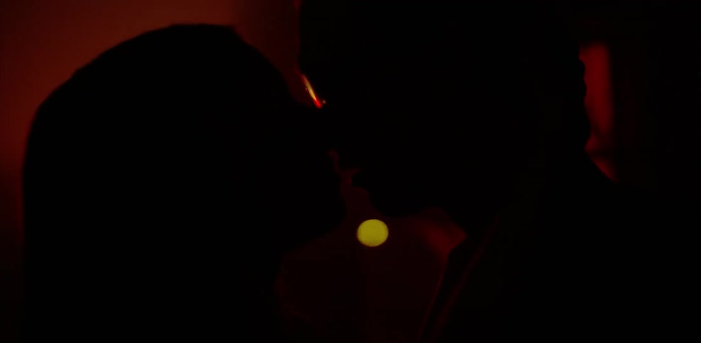 Two people making out in red light