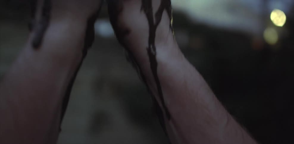 A person lets mud drip down their hands as they look at them