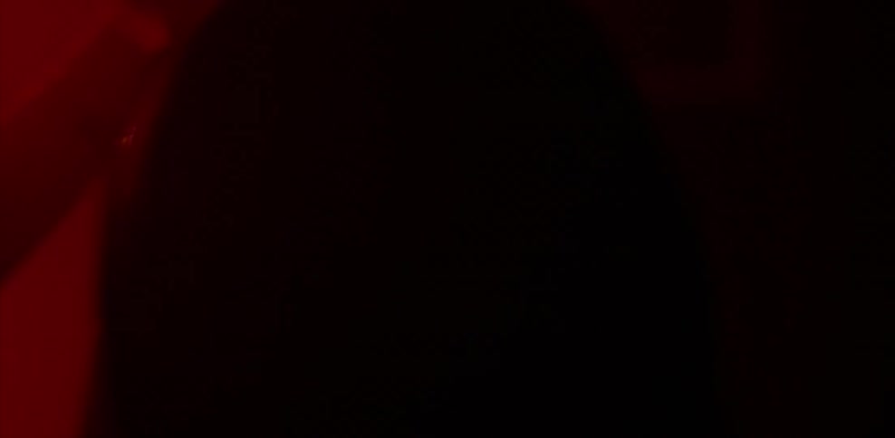 Man and woman hug and kiss in red light