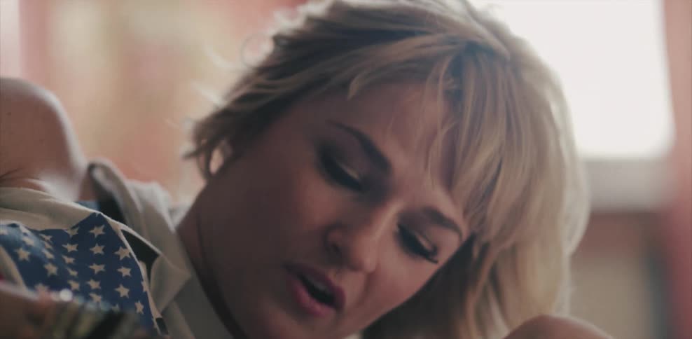 Woman laying in bed talking and smiling