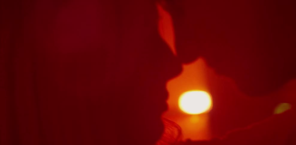Man and woman hugging in red light