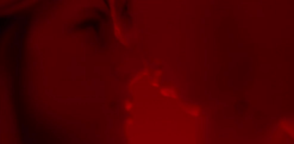 Man and woman making out in red light
