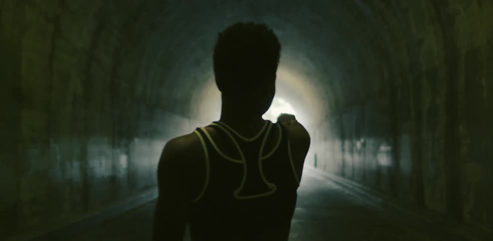 Woman standing in a tunnel pointing