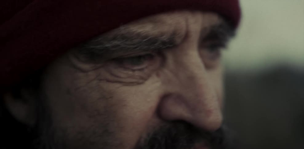 Close up of elderly man's face as he looks around outside