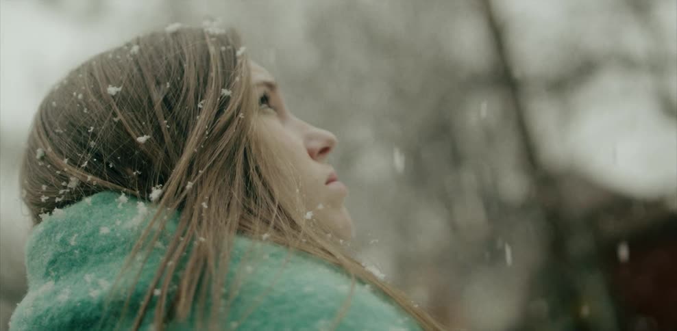 A woman is standing in the snow