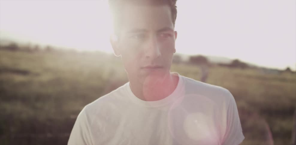 A man stands in the middle of a field