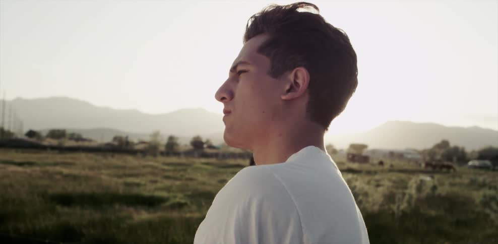 A man outside in a field staring at something