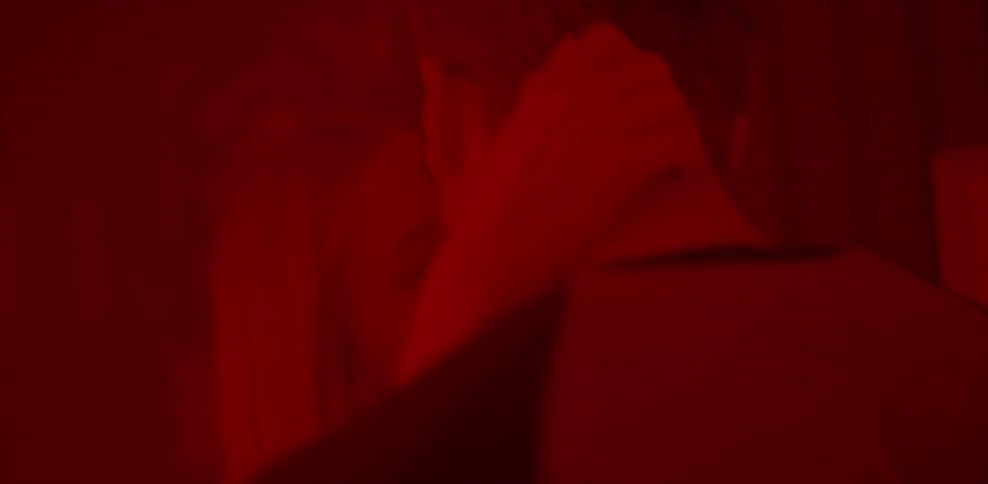 Man and woman making out in red light