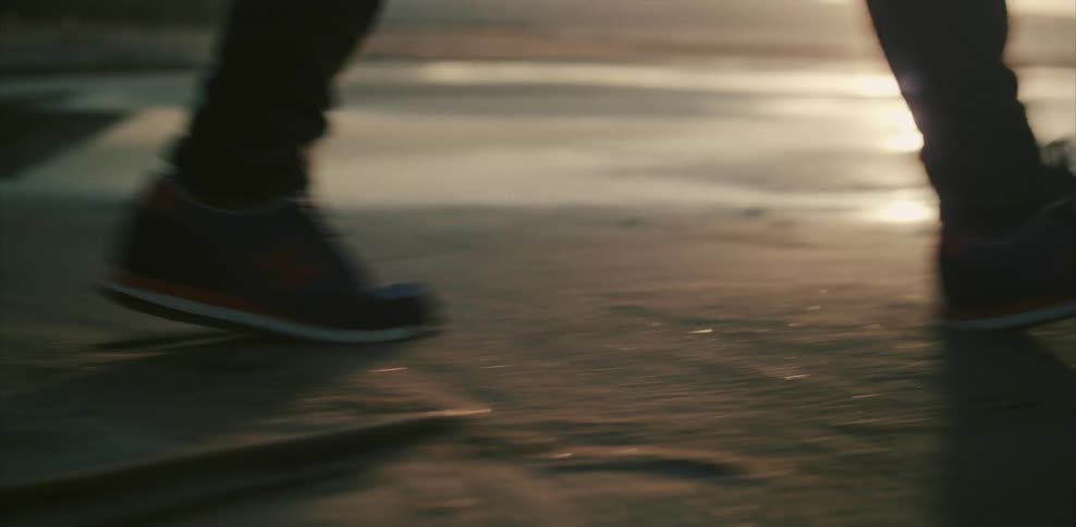 Person walking on sandy landscape near water