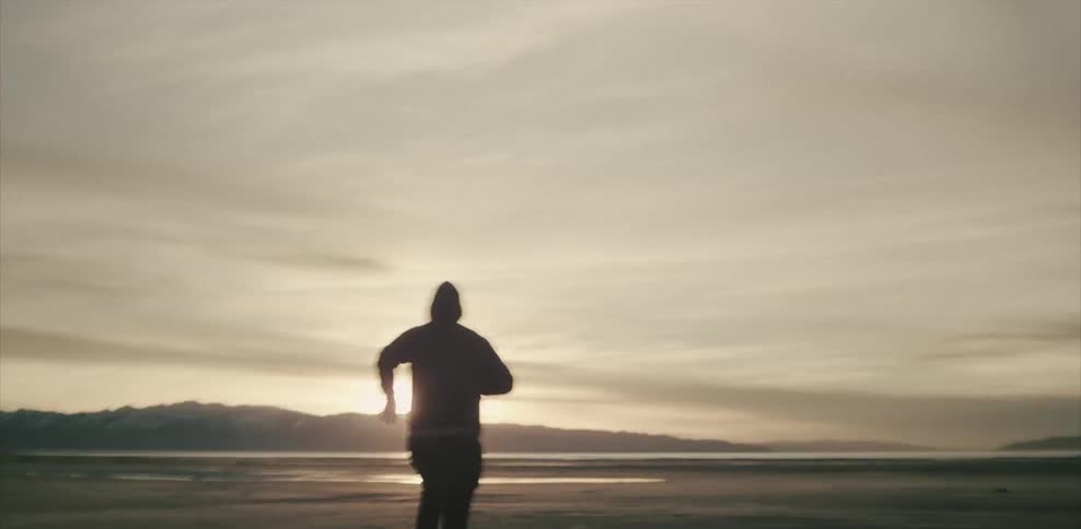 Man running across flat plains to water