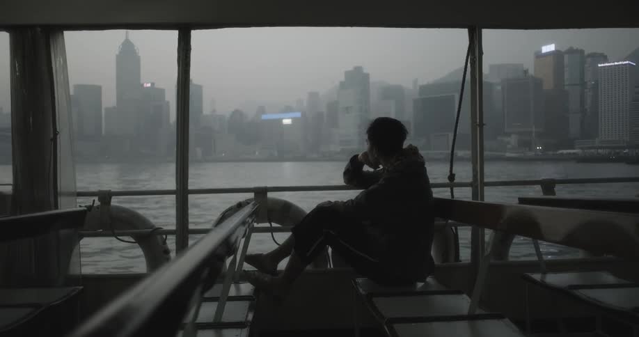 A person is riding a ferry towards the city