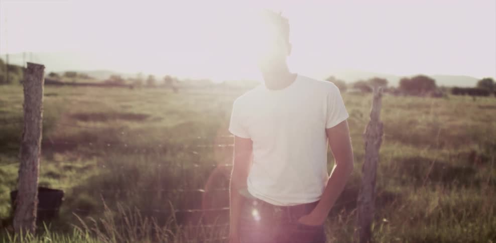 A man stands in the middle of a field