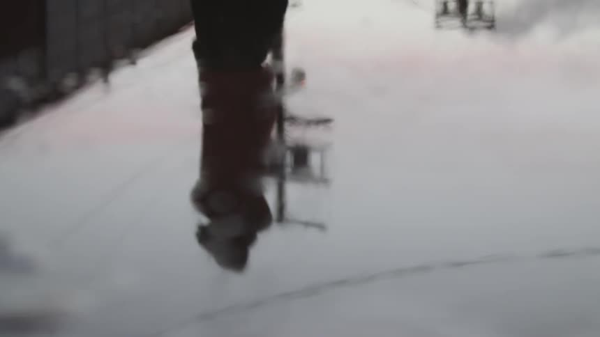 A man is reflected in a puddle while it rains