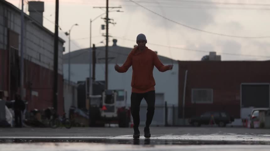 A man jumps rope in the street