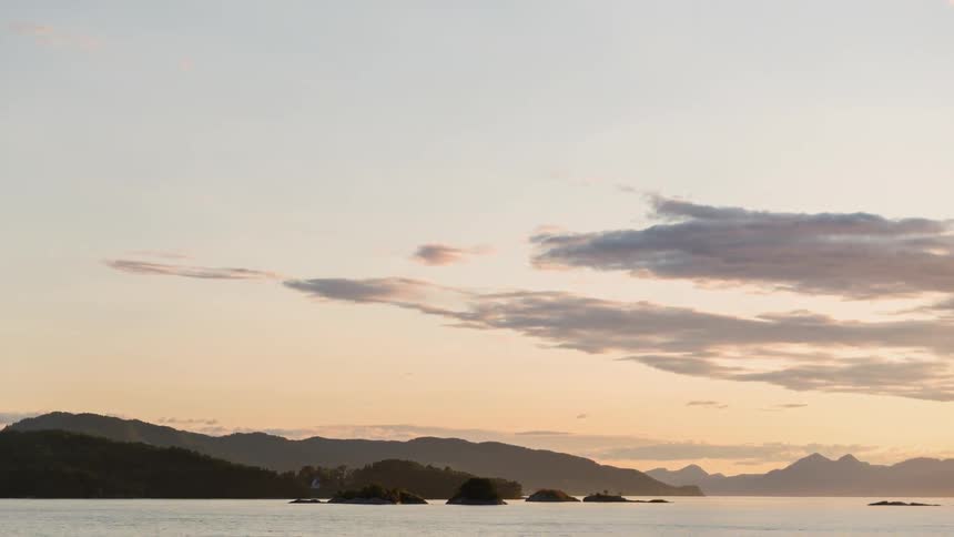 Traveling view of islands in the sea with a mountain background