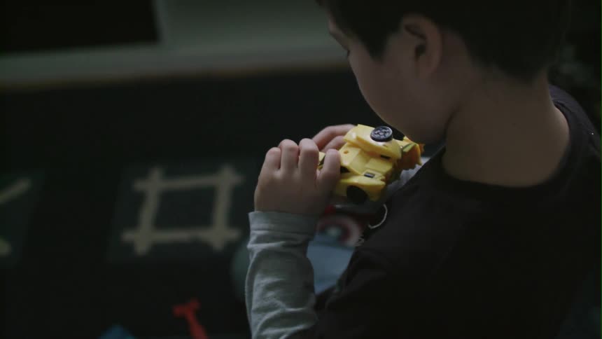 A child assembles a small toy
