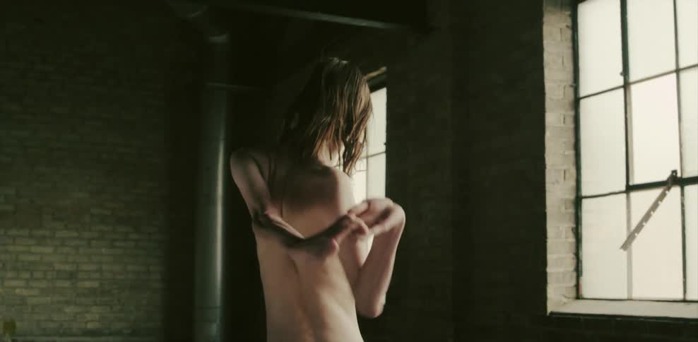 A man stretches and contorts his arms from behind his back