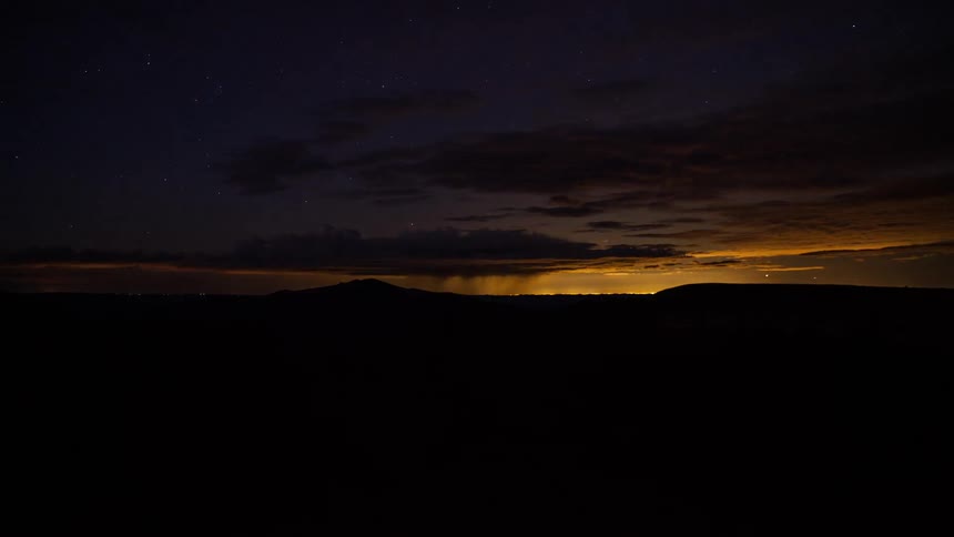 Time lapse of clouds over a valley at sunset