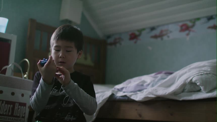 Child plays with toys in a bedroom
