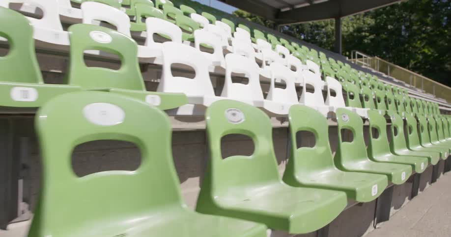 The bleachers have green and white seats