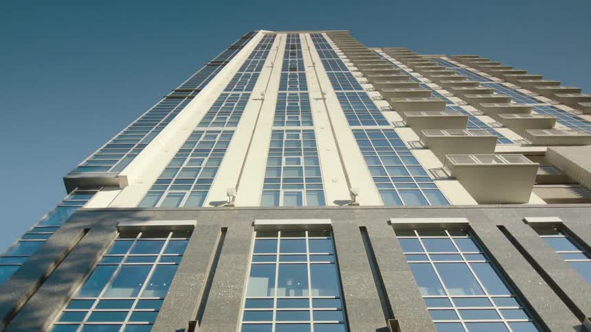 View of a tall building from the street looking up towards the sky