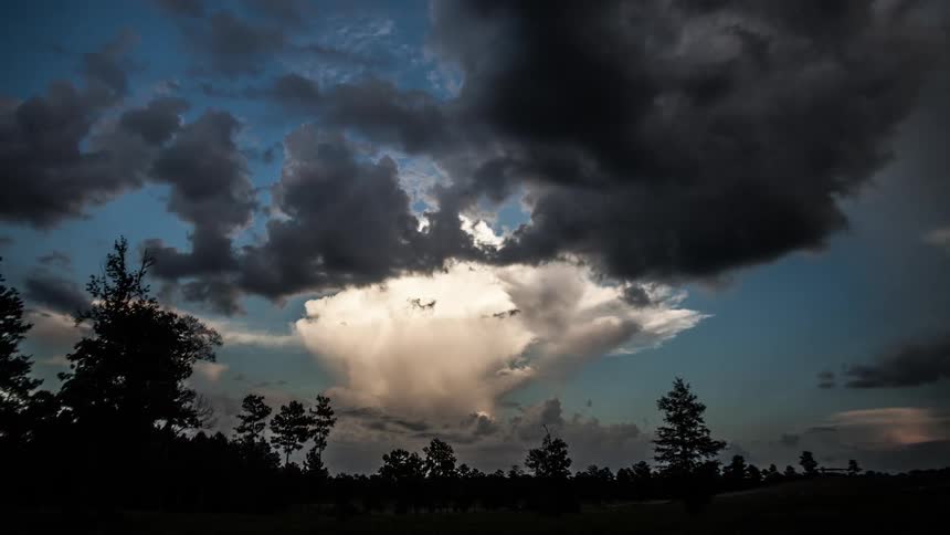 Storm clouds moving in over a rural area