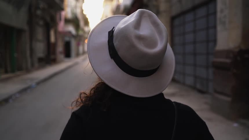 Woman walking down an alleyway in the city