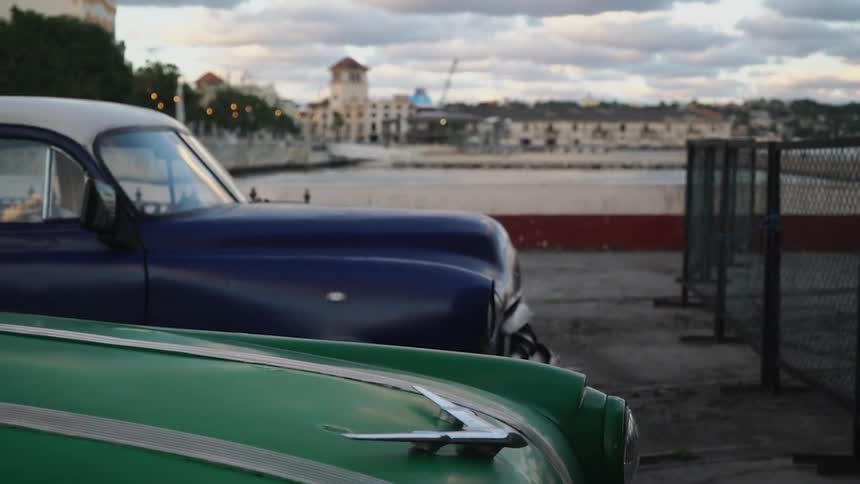 Antique cars are parked in a city