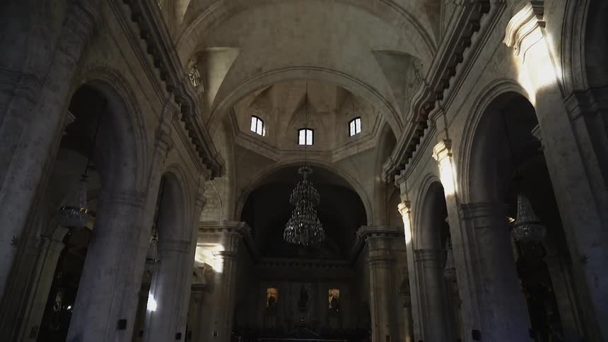 The inside of the hall is all stone with a statue ahead