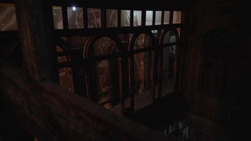 Old beams run across a dimly lit building