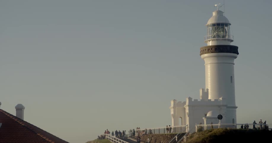 A white lighthouse towers into the sky