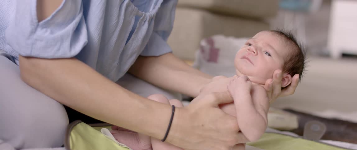 A woman is holding a newborn baby
