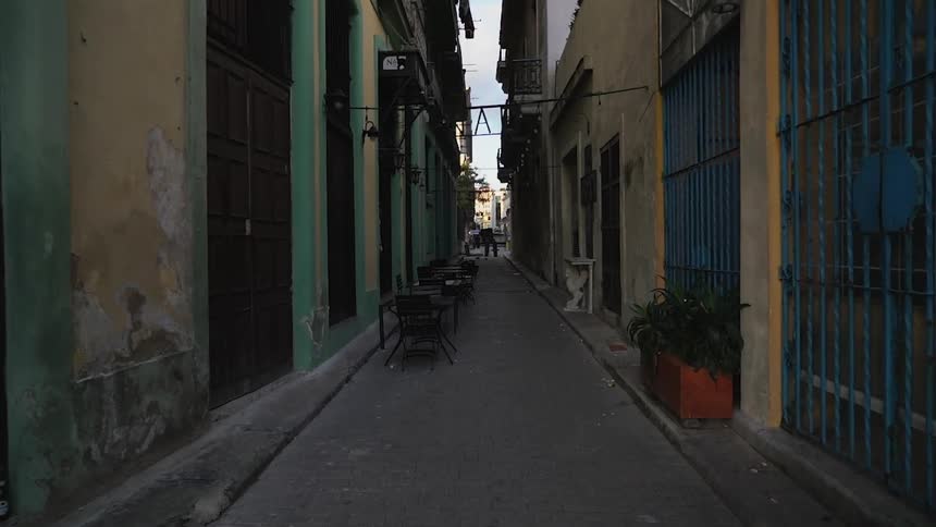 Planters, chairs and tables occupy the city alleyway