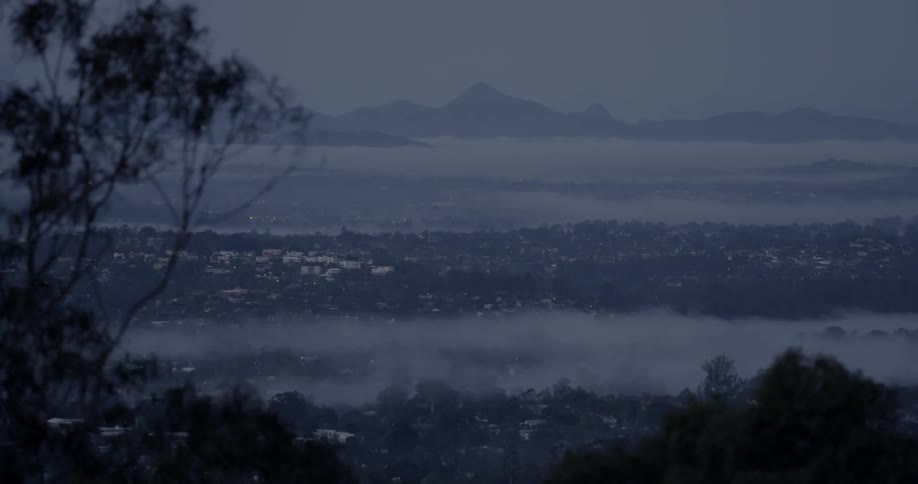 The town ahead is covered with dense fog