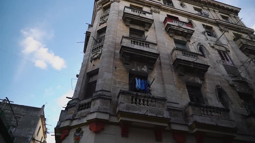 A stone apartment building towers into the sky