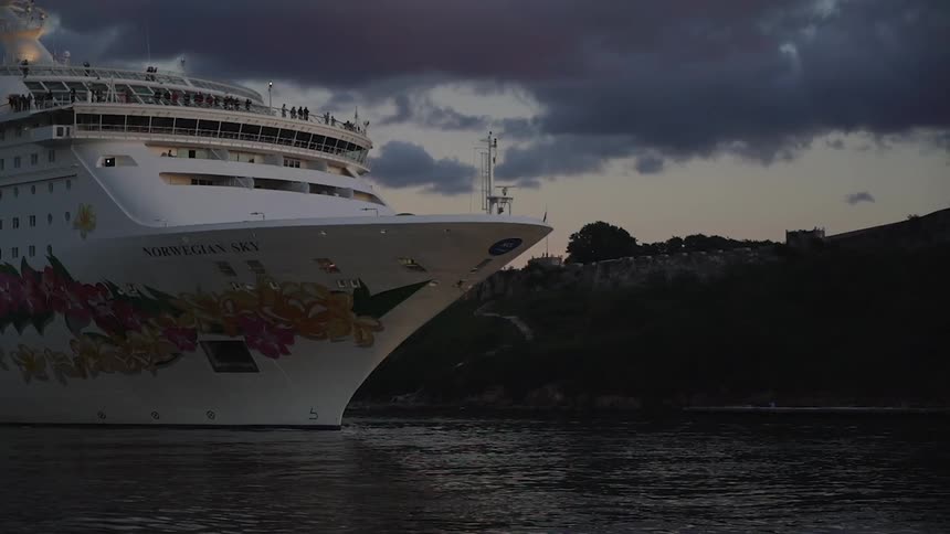 A large ship sails in the water full of people