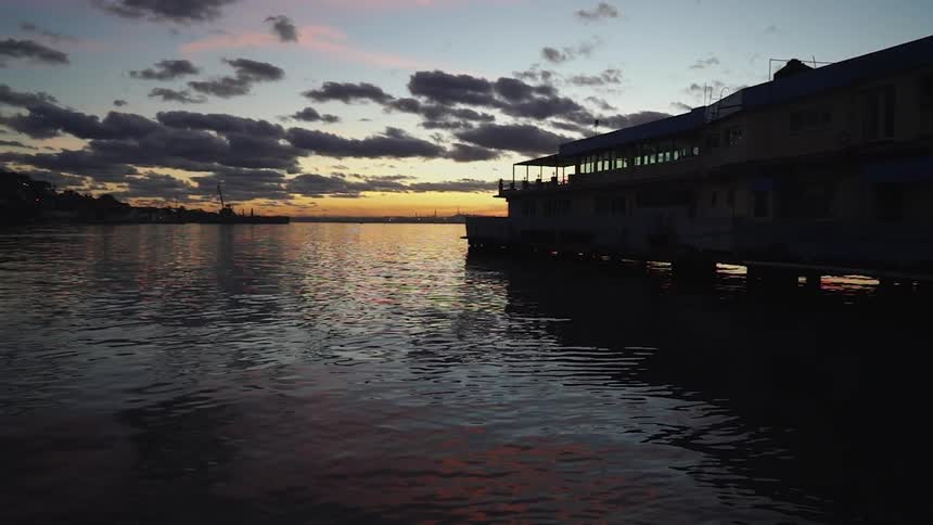 The long pier has calm water at sunset