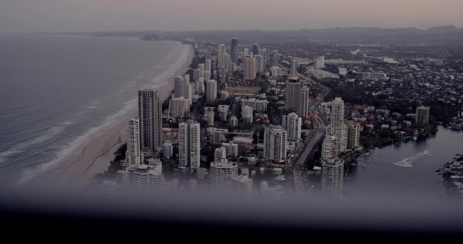 Skyscrapers line the coast at sunset