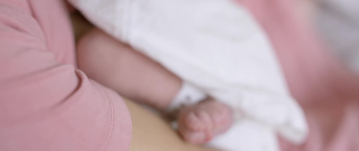 A baby squirms his feet
