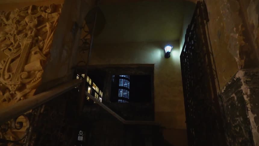 Ornate decorations line a dimly lit staircase