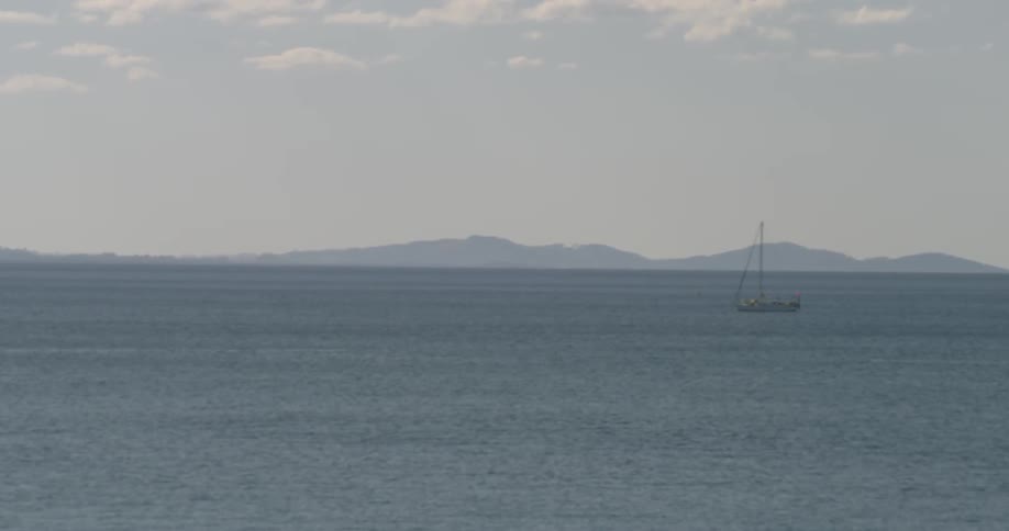 A lone boat sails on open water