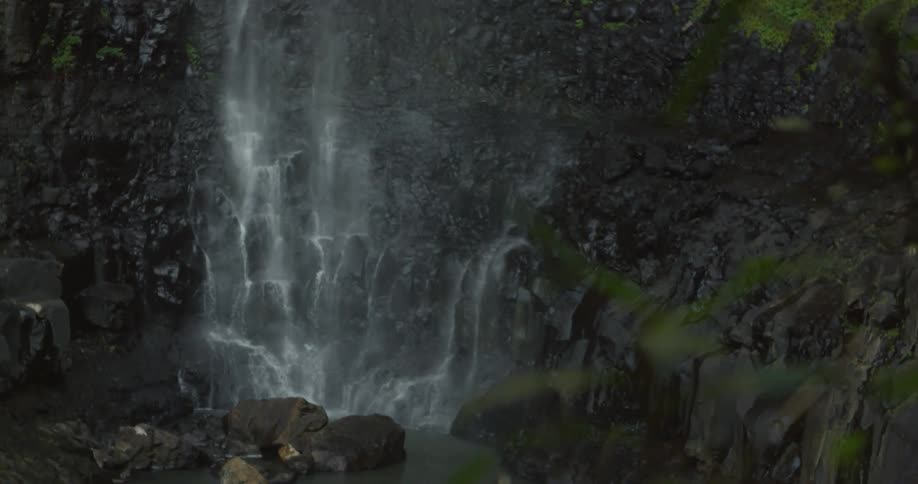 A waterfall cascades over a rocky cliff