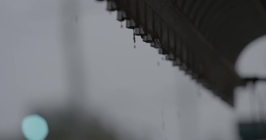 Snow falls off of a tin roof