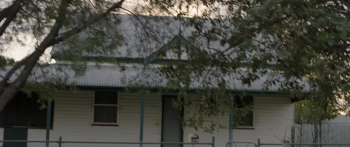 A small and rural house is shown at sunset
