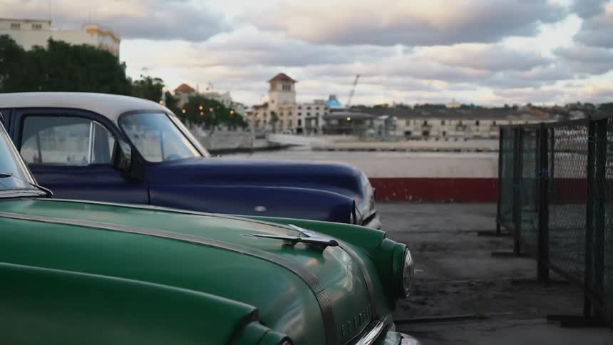 Cars are parked in a lot by the pier