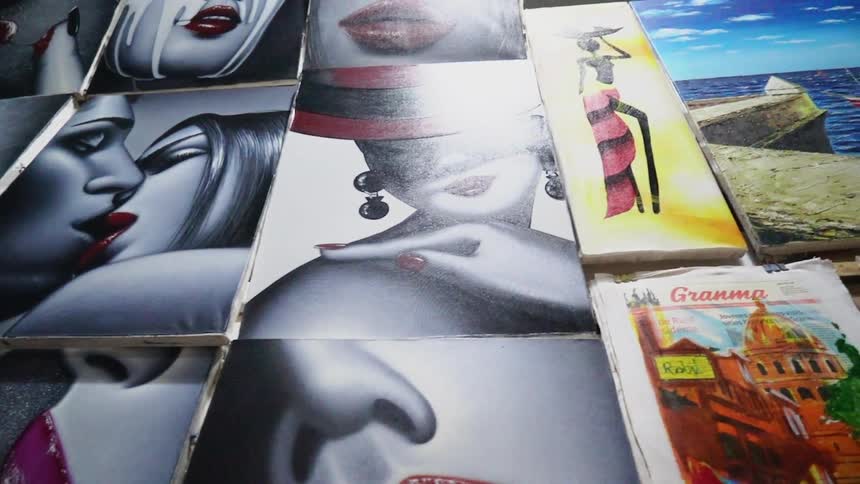 Paintings are on the wall of different people and areas