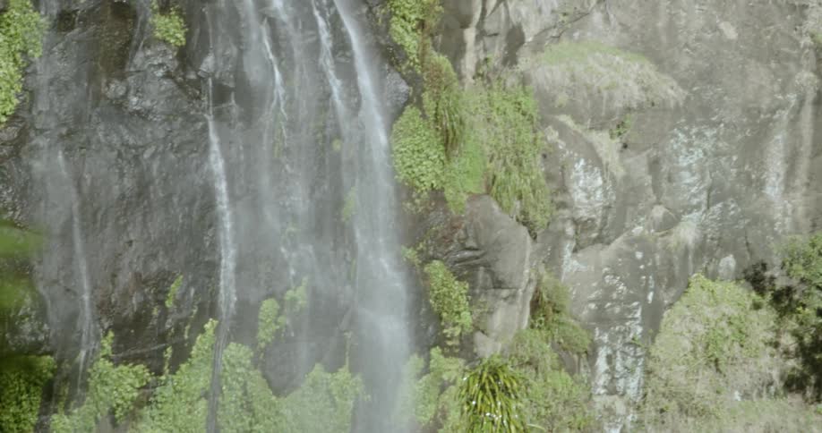 A waterfall bounces off a rocky cliff