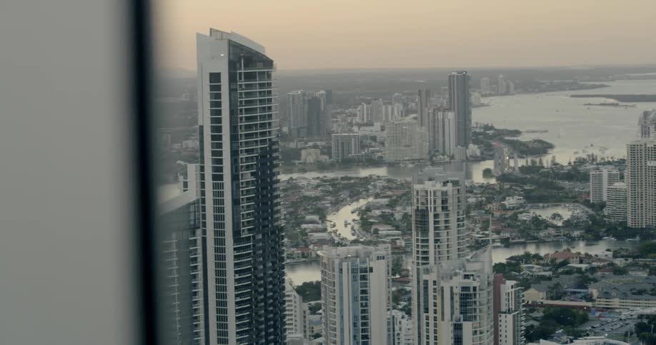 City skyscrapers are seen from a window at sunset